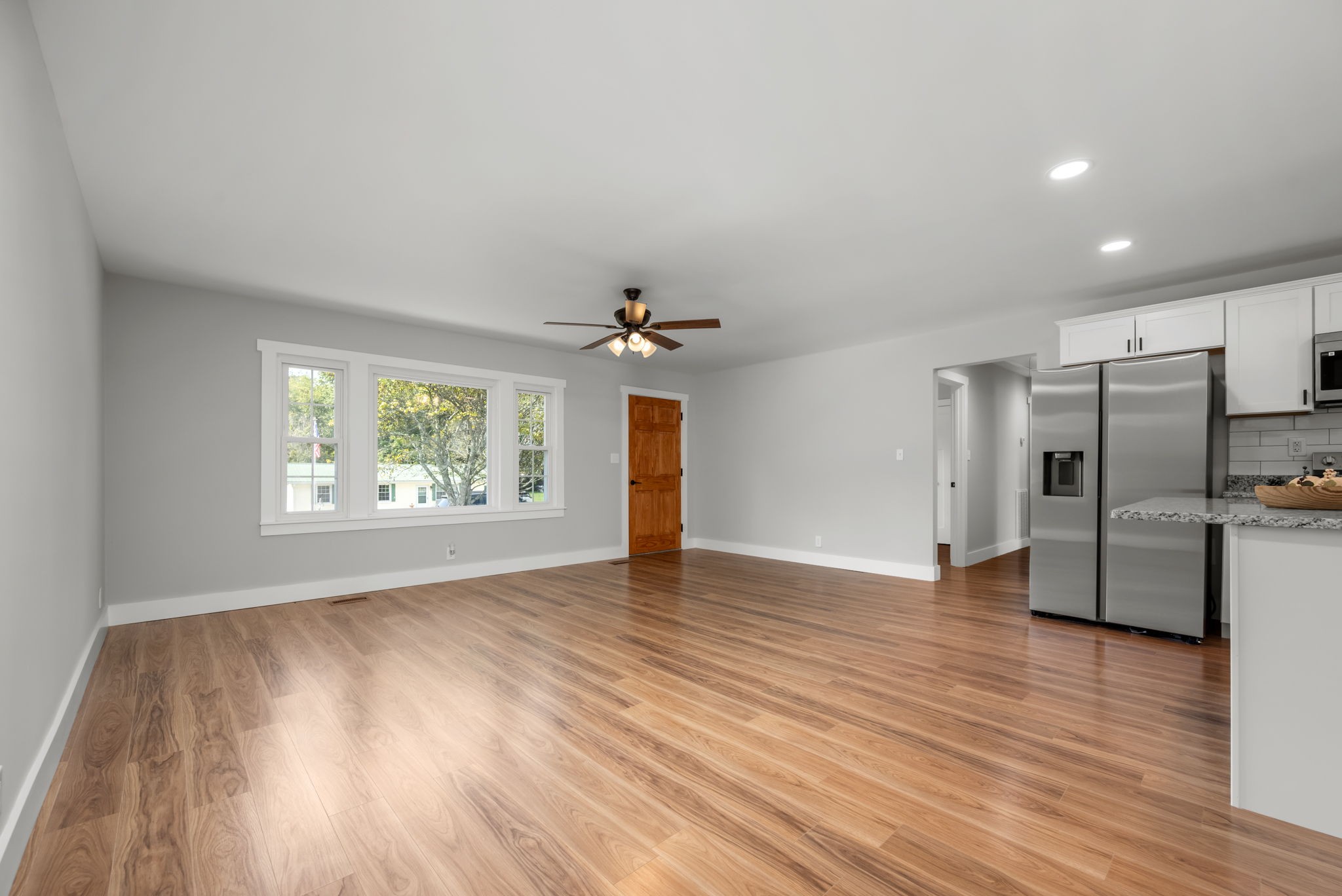 210 Rigney Drive Manchester, TN 37355 - Photo 11 of 39 an empty room with wooden floor chandelier and windows