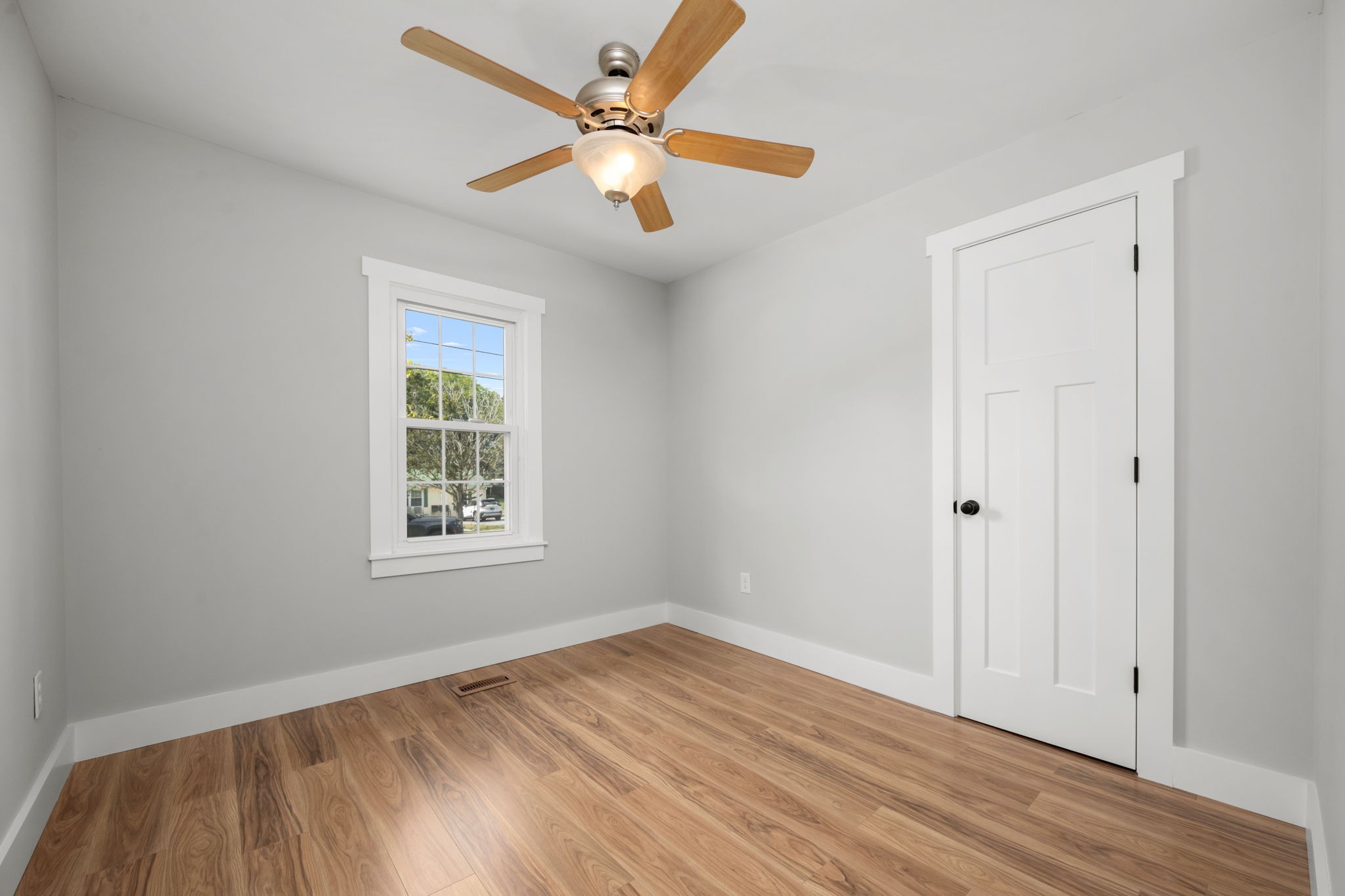 210 Rigney Drive Manchester, TN 37355 - Photo 19 of 39 an empty room with wooden floor fan and windows