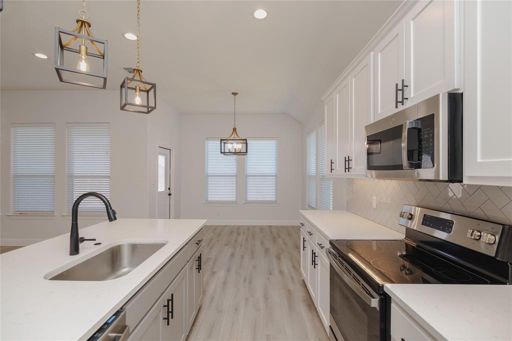 520 Mustang Lane Pilot Point, TX 76258 - Photo 14 of 15 a kitchen that has a sink and a stove