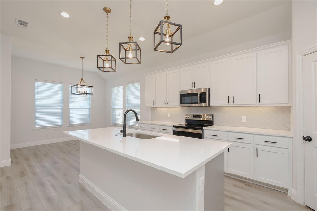 520 Mustang Lane Pilot Point, TX 76258 - Photo 15 of 15 a kitchen with a sink a microwave and cabinets