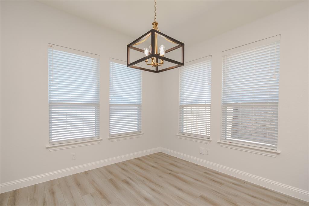 520 Mustang Lane Pilot Point, TX 76258 - Photo 7 of 15 an empty room with windows and a ceiling fan