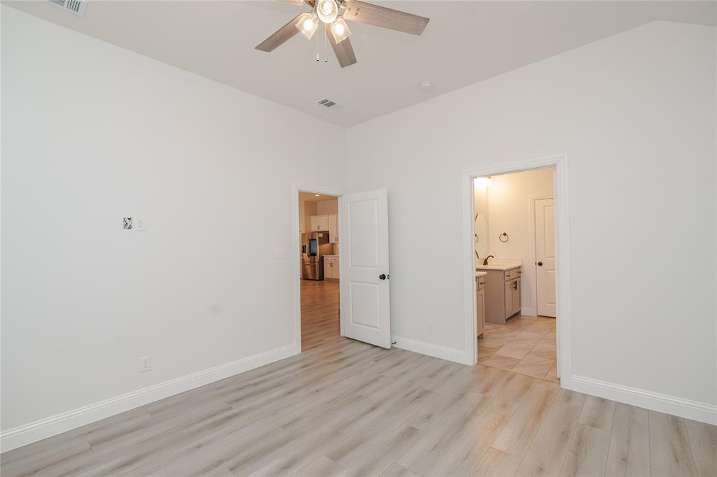 520 Mustang Lane Pilot Point, TX 76258 - Photo 8 of 15 an empty room with wooden floor and ceiling fan
