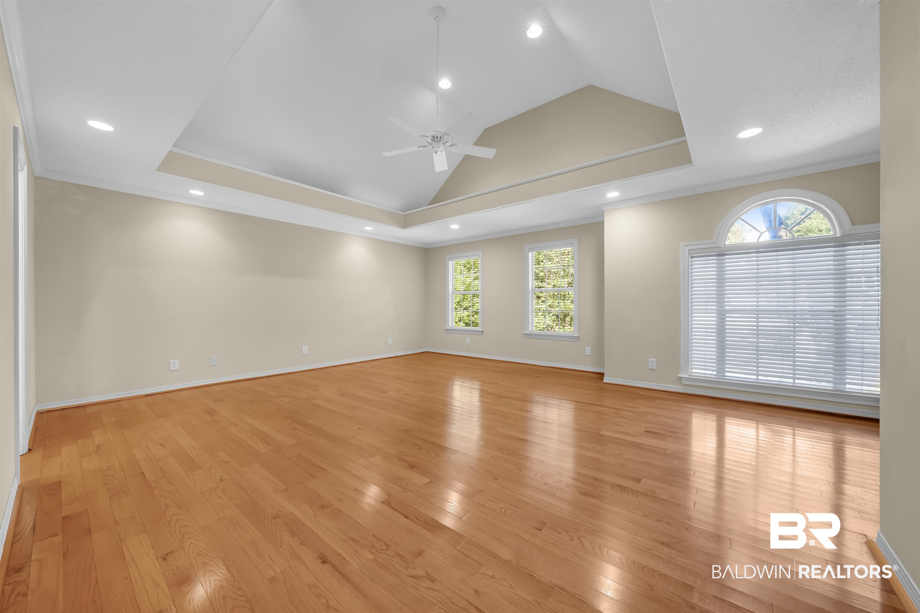 1262 Patrick Street Daphne, AL 36526 - Photo 29 of 35 Spare room featuring crown molding, light wood-style flooring, a tray ceiling, recessed lighting, and a ceiling fan