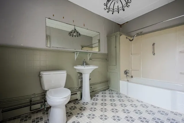 a bathroom with a toilet sink and shower