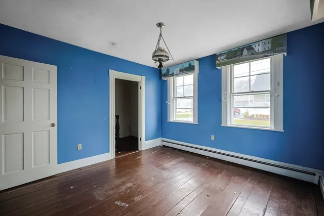 a view of room with window wooden floor and windows