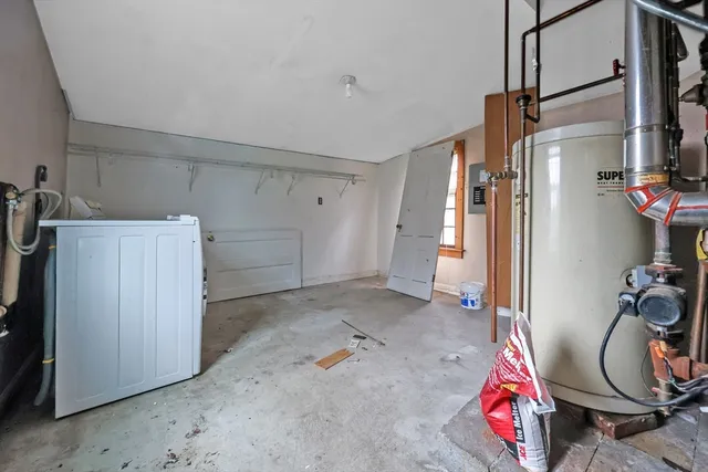 a view of storage and utility room with closet
