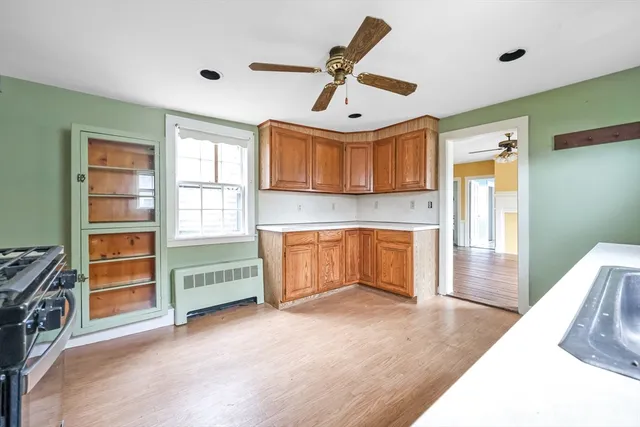 a view of a livingroom with a fireplace and a window