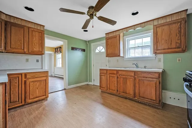 a spacious bathroom with a granite countertop sink mirror and a bathtub