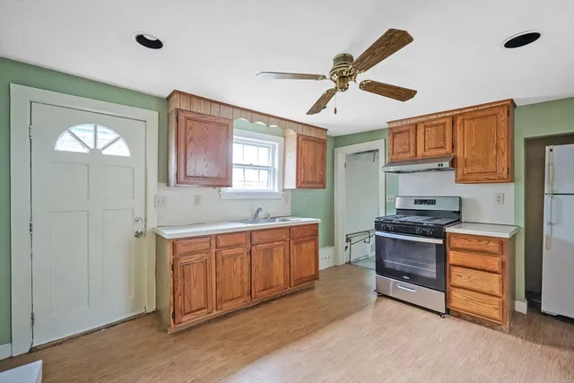 a kitchen with stainless steel appliances granite countertop a stove and a sink