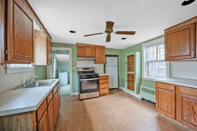 a kitchen with stainless steel appliances kitchen island granite countertop a sink and a stove