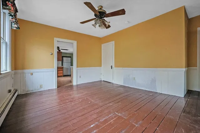 wooden floor in an empty room with a window