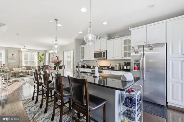 a kitchen with appliances a sink and cabinets