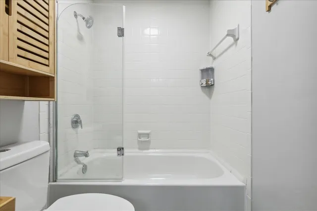 a bathroom with a bathtub and a toilet