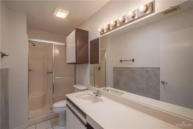 a view of kitchen with refrigerator cabinets and furniture
