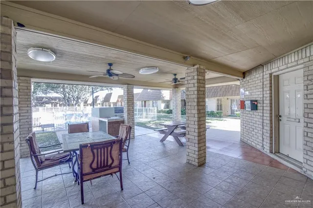 a dining room with furniture large windows and wooden floor