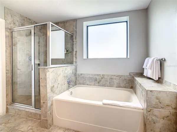 a bathroom with a bathtub and a shower
