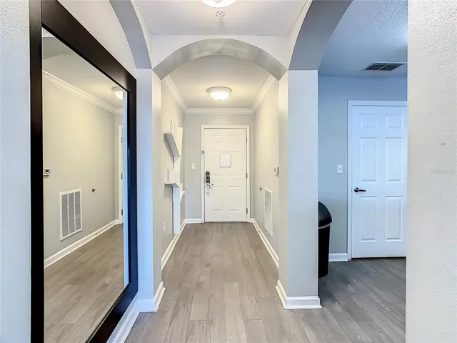 a view of a hallway with wooden floor