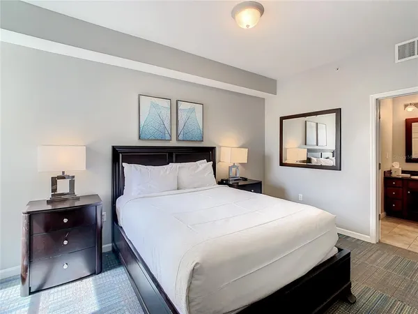 a bedroom with a bed and a lamp on table