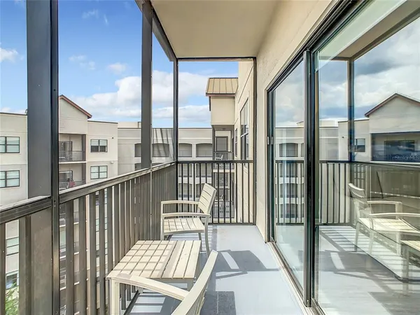 a view of a balcony with floor to ceiling window
