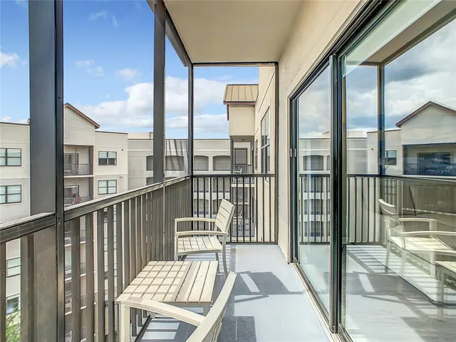 a view of a balcony with floor to ceiling window