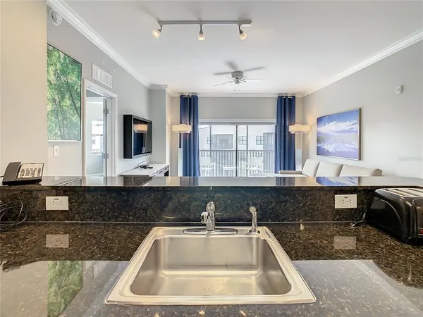 a kitchen with a sink and a stove top oven with a granite countertops
