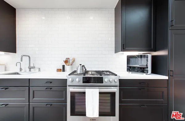 a kitchen with a sink and a stove