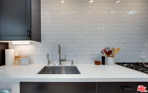 a kitchen with a sink and a stove top oven