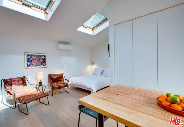 a bedroom with a bed and a table in it