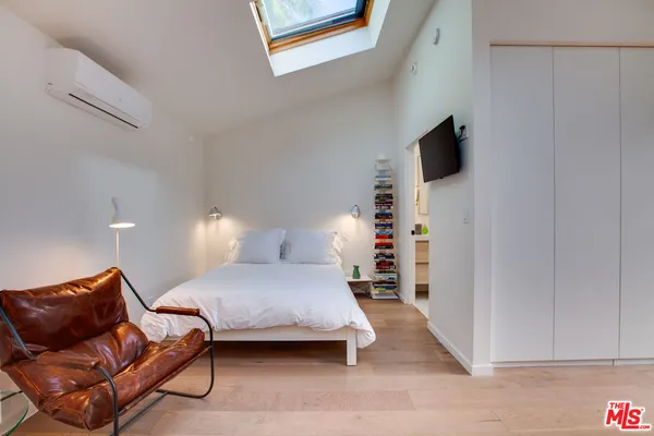 a bedroom with a bed and a couch