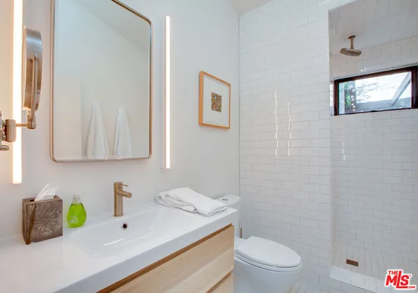 a bathroom with a sink vanity and toilet