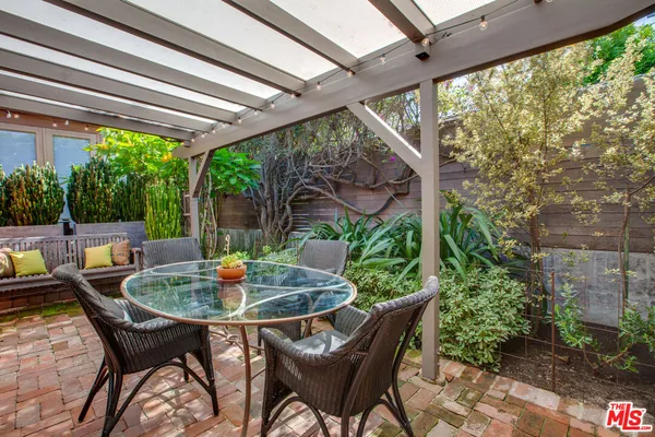 a view of backyard with outdoor seating and green space