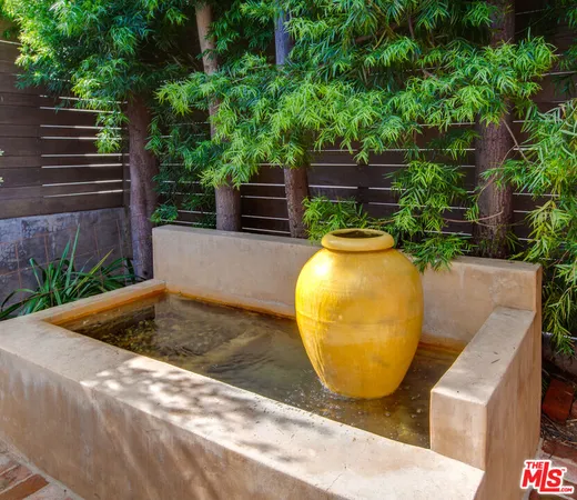 a view of a swimming pool with some potted plants