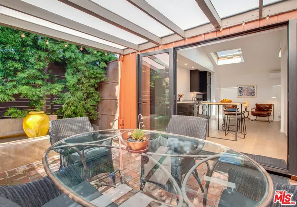 a living room with furniture and floor to ceiling windows