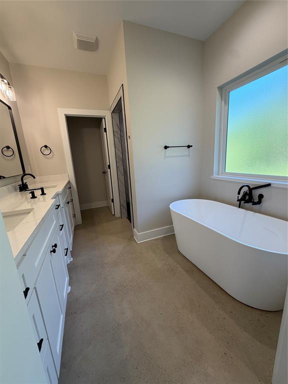 304 Lake Road Plain Dealing, LA 71064 - Photo 14 of 16 a spacious bathroom with a tub sink and mirror