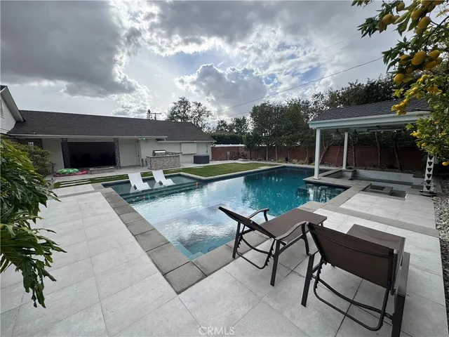 a swimming pool with outdoor seating and yard
