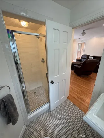 a bathroom with a glass door shower and a sink