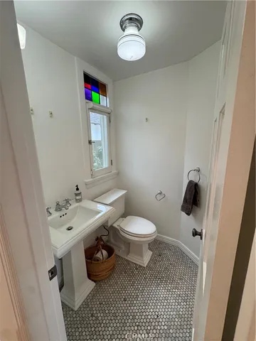 a bathroom with a sink a toilet and a shower