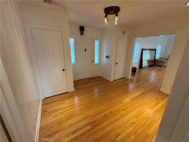 a view of a hallway with wooden floor