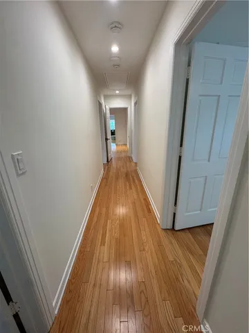 a view of hallway with wooden floor