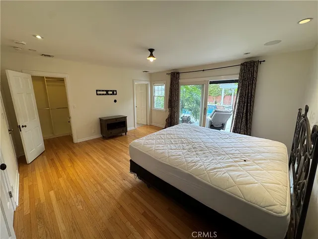 a bedroom with a bed and a large window