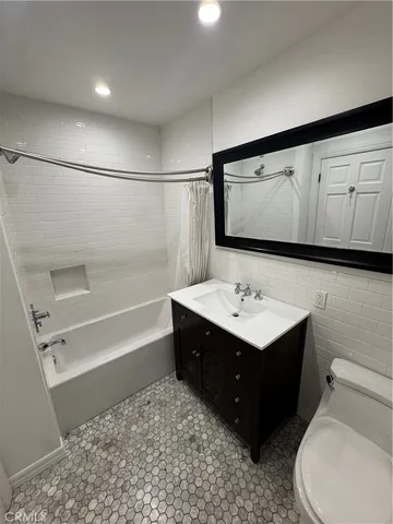 a bathroom with a sink vanity mirror and toilet