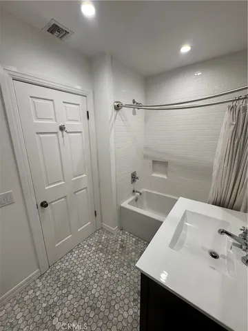 a bathroom with a sink and shower