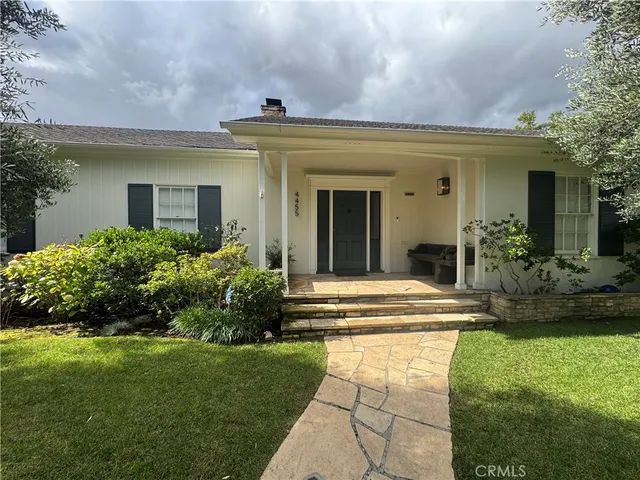 a view of a house with a fountain in front of a house
