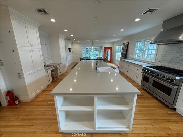 a view of a kitchen with stainless steel appliances granite countertop a stove and a refrigerator