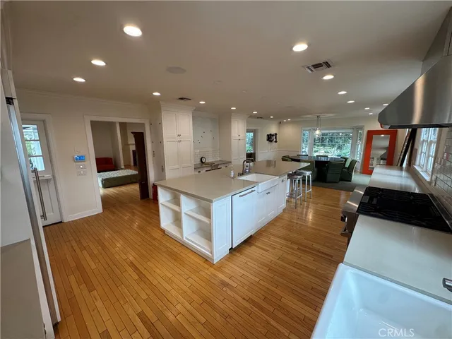 a large kitchen with stainless steel appliances kitchen island a large counter top and a sink