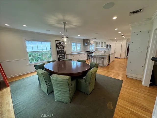 a dining room with furniture and wooden floor