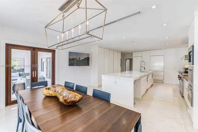 a living room with furniture a window and a flat screen tv