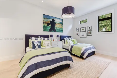 a bedroom with bed and a chandelier