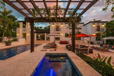 a view of a park with plants and palm trees