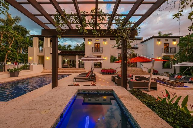 a view of a park with plants and palm trees